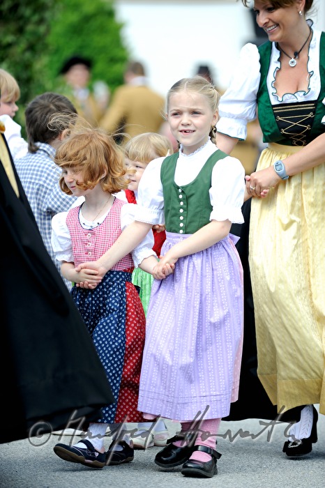 children dance around the maypole