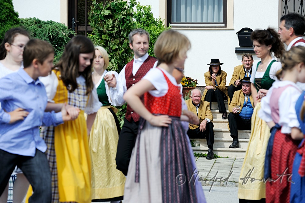 dancers dance around the maypole