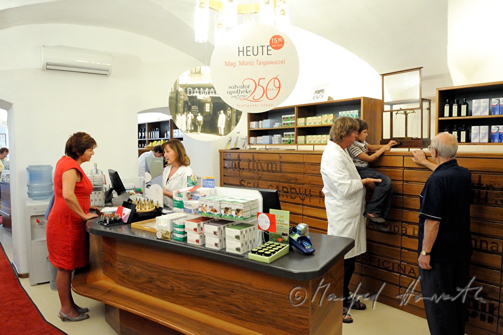 pharmacist shows his clients the old balance