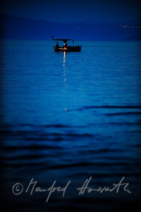fisherman in the bay fishing by night
