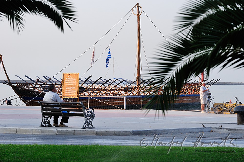 fishermen near a galley in the harbour