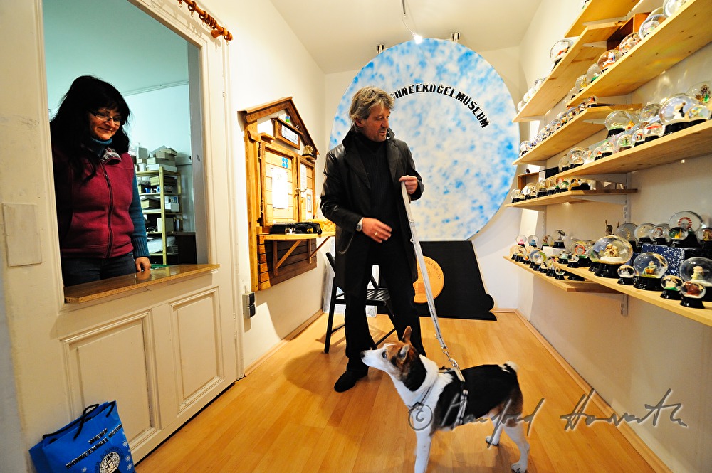 visitor with his pet in the snow globe museum