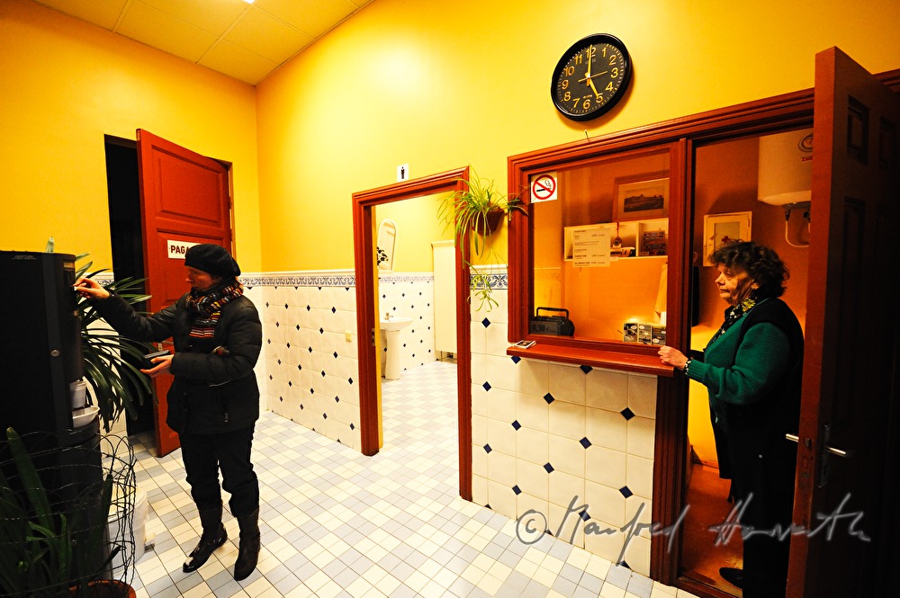 railway station, lavatory attendant and customer at the automatic coffee maker
