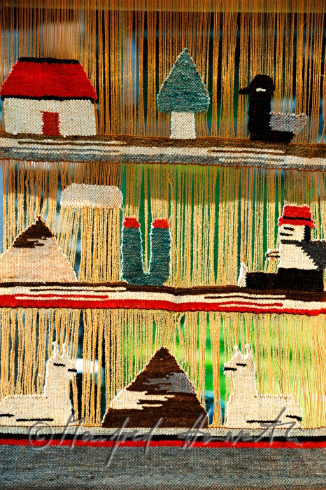 lamas on a woven wall hanging