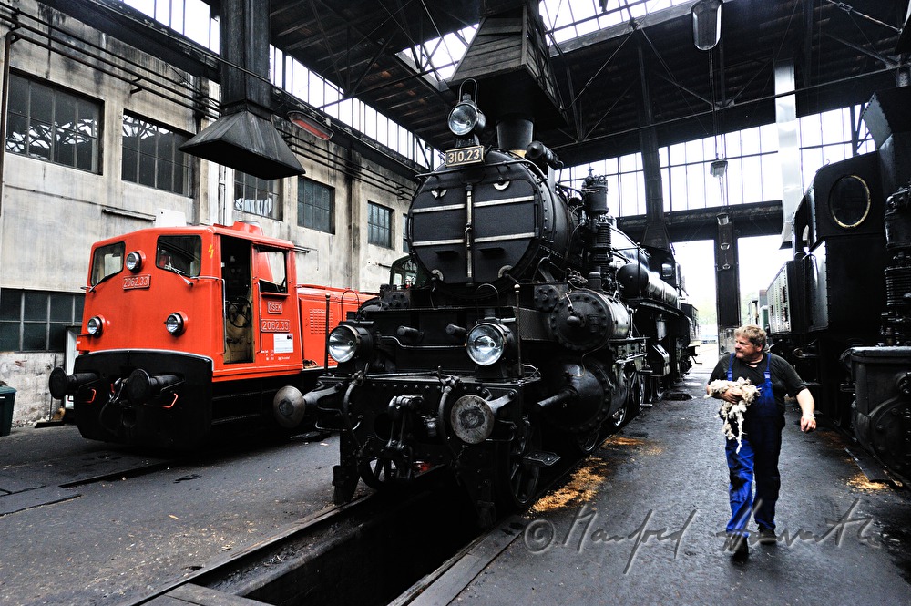 mechanic in the remise carrying cotton waste