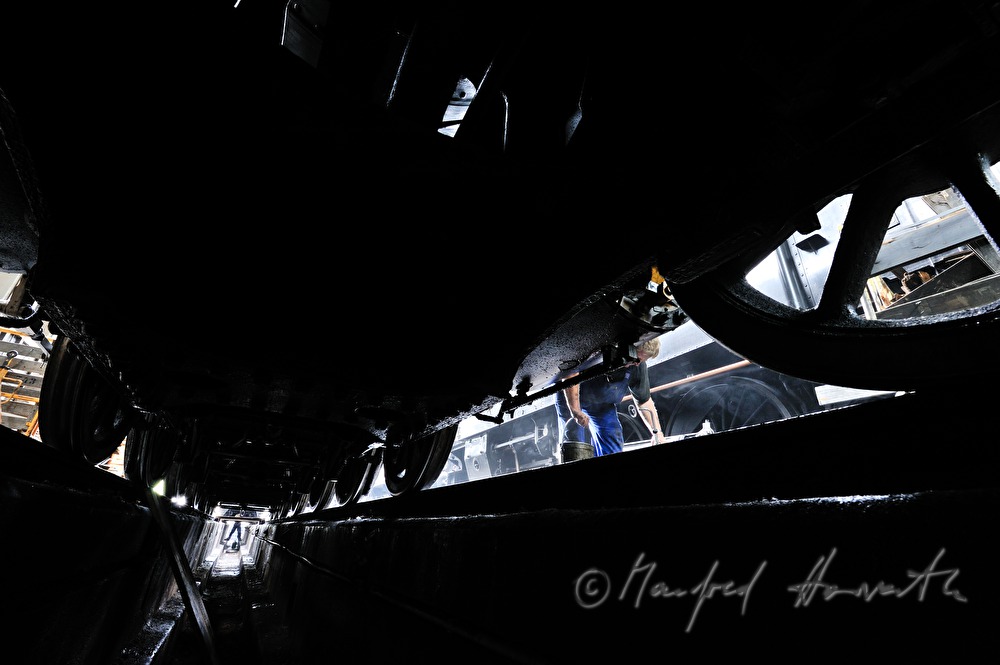 engine driver of the old locomotive 190.13 greasing the arbor