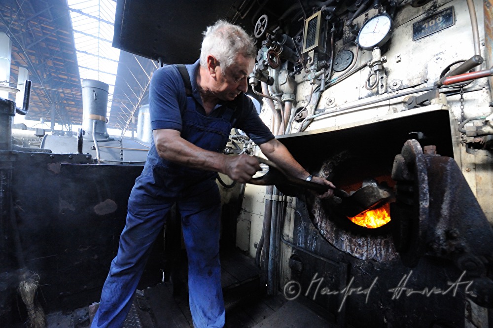 boilerman firing the steam locomotive kkStB 310.23
