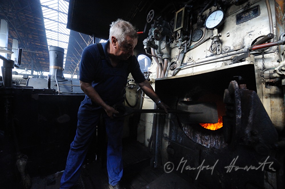 boilerman firing the steam locomotive kkStB 310.23