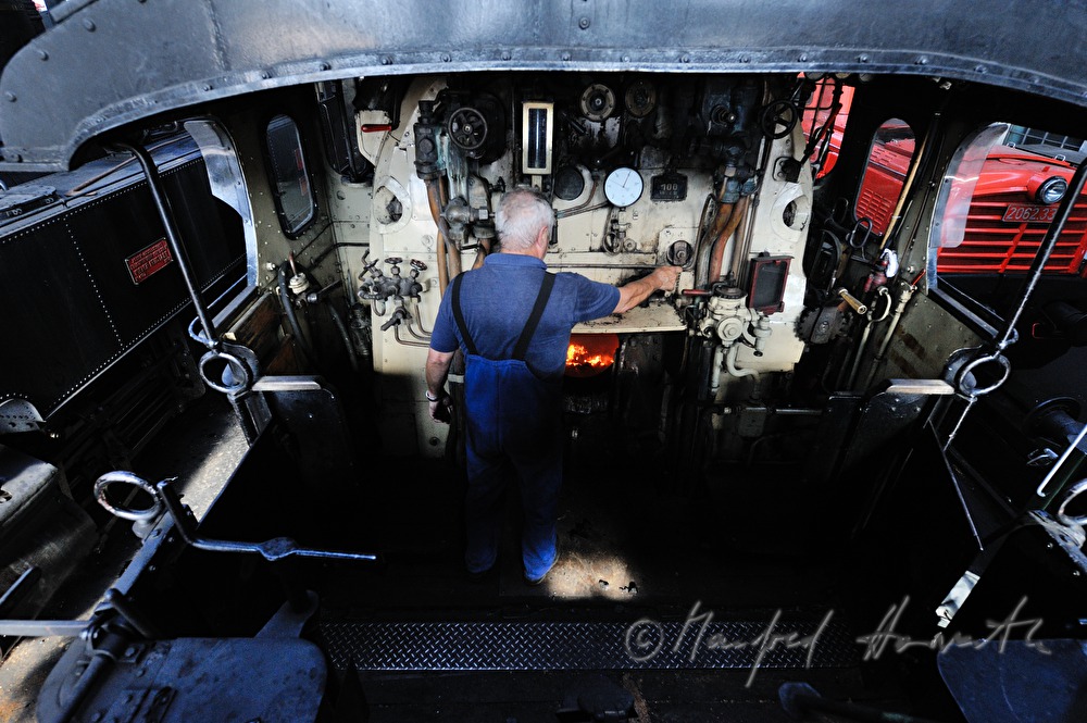 boilerman firing the steam locomotive kkStB 310.23