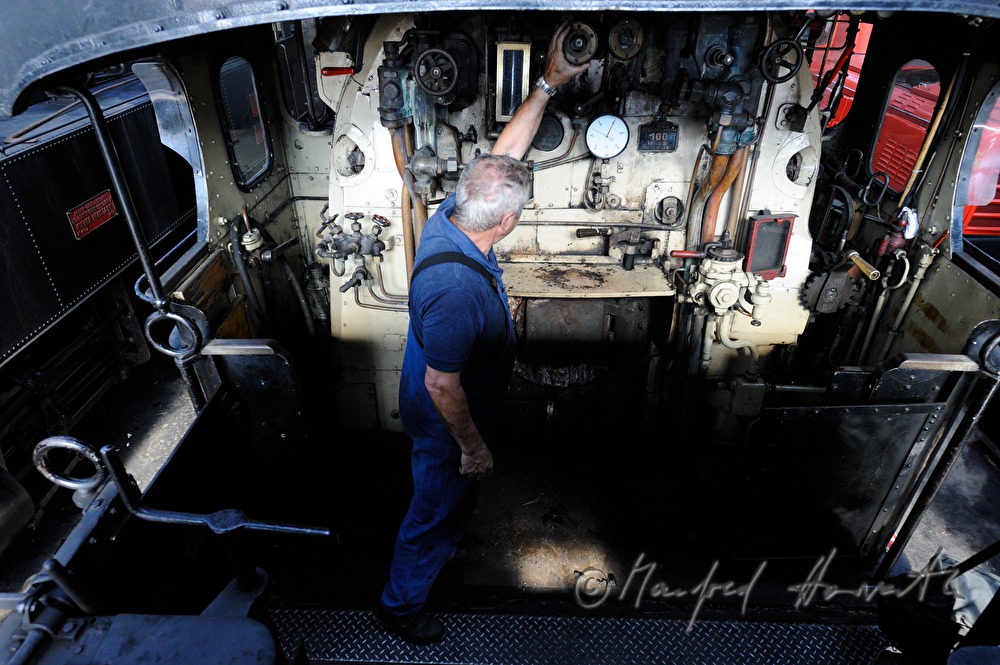 boilerman at the footplate of the steam locomotive kkStB 310.23