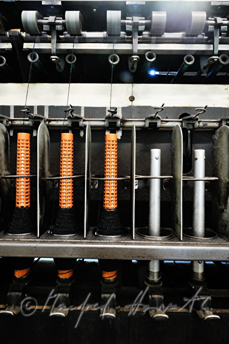 coils with thread on the winding machine