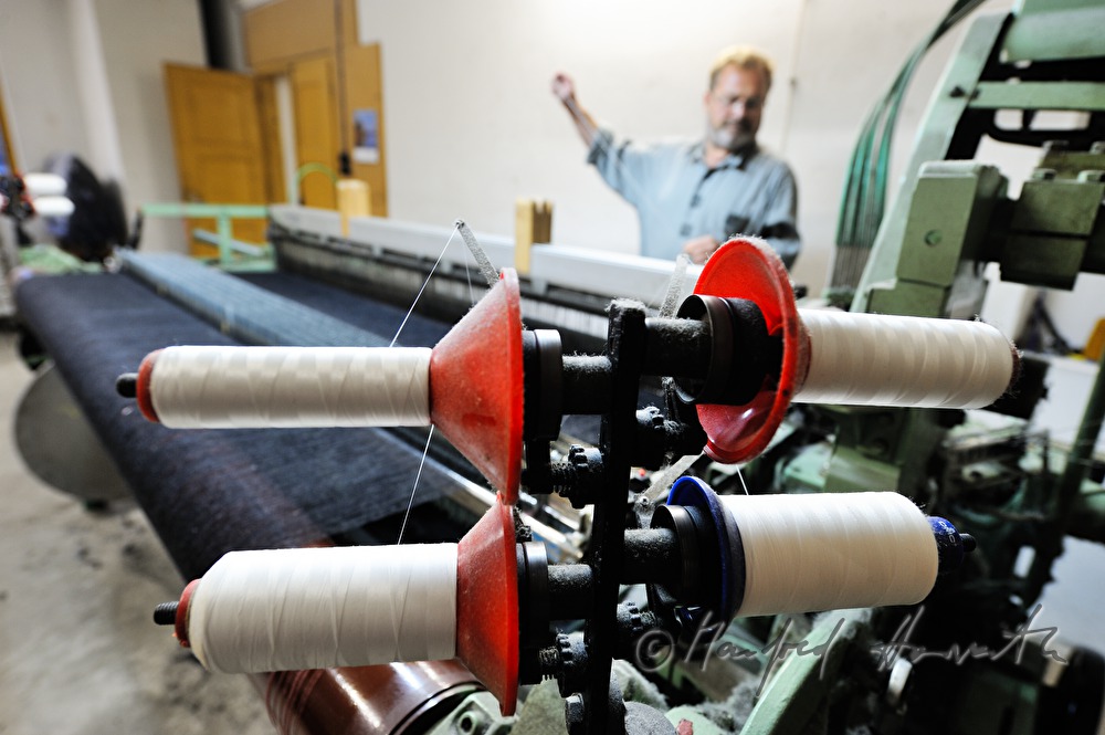 worker changing coil at the loom
