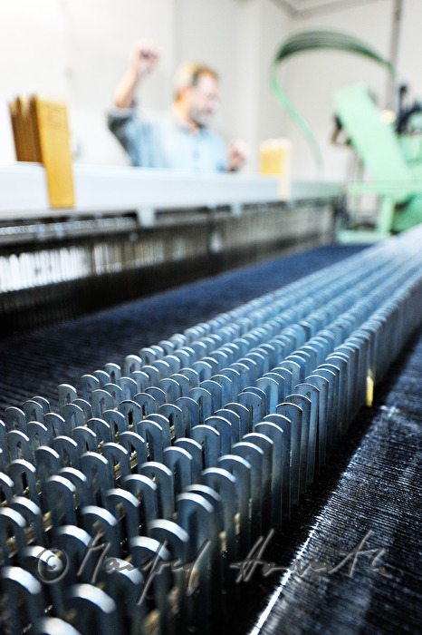 worker changing coil at the loom