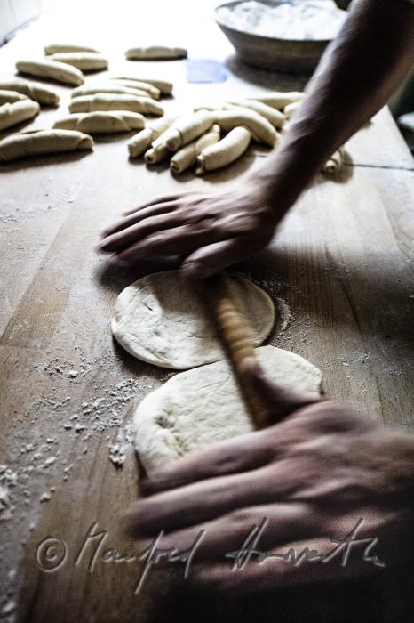 kneading the dough with a round wood