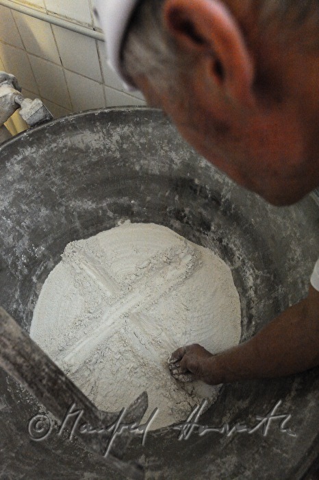 drawing a crucifix in the sour dough