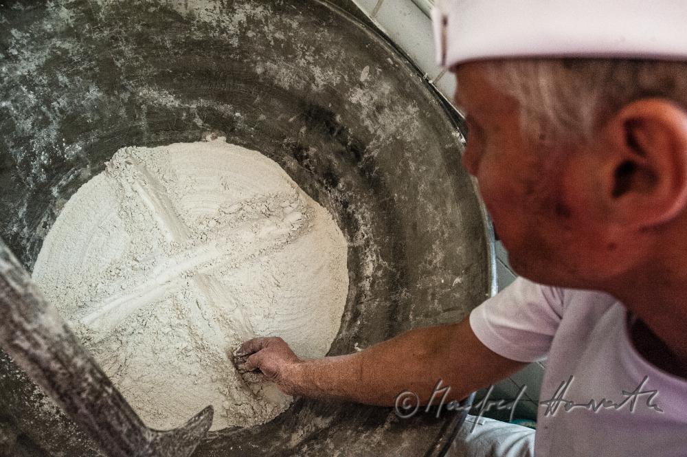 drawing a crucifix in the sour dough