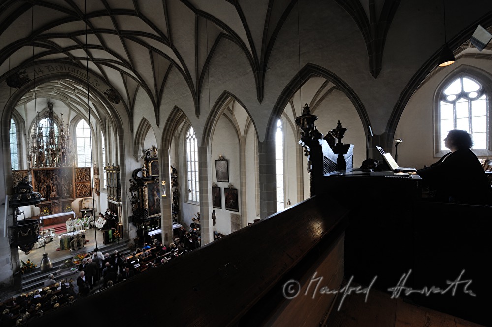 musician plays the church organ during the mass
