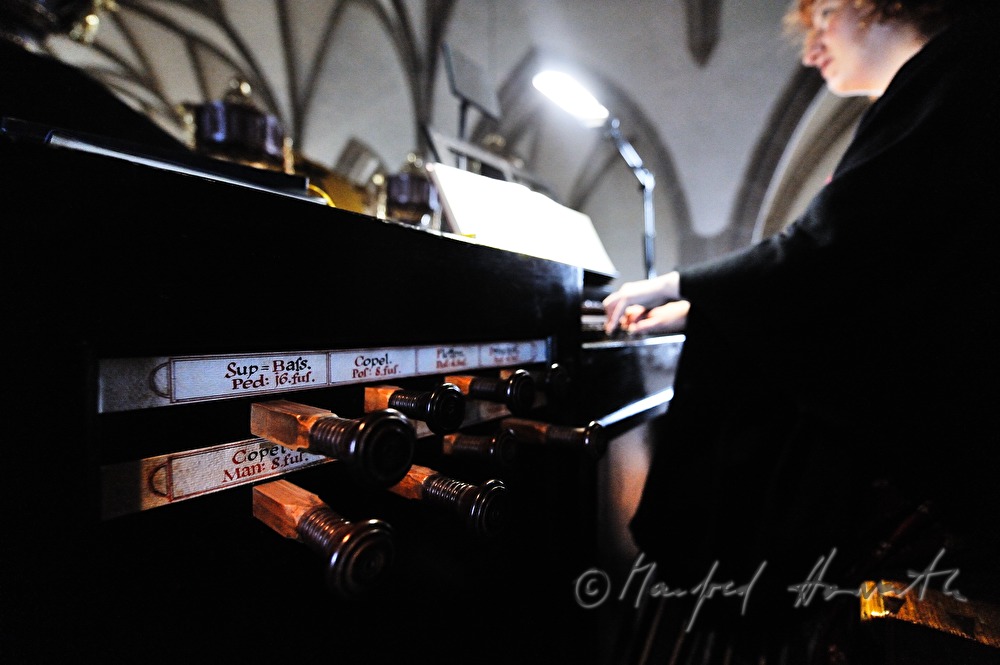 musician plays the church organ during the mass