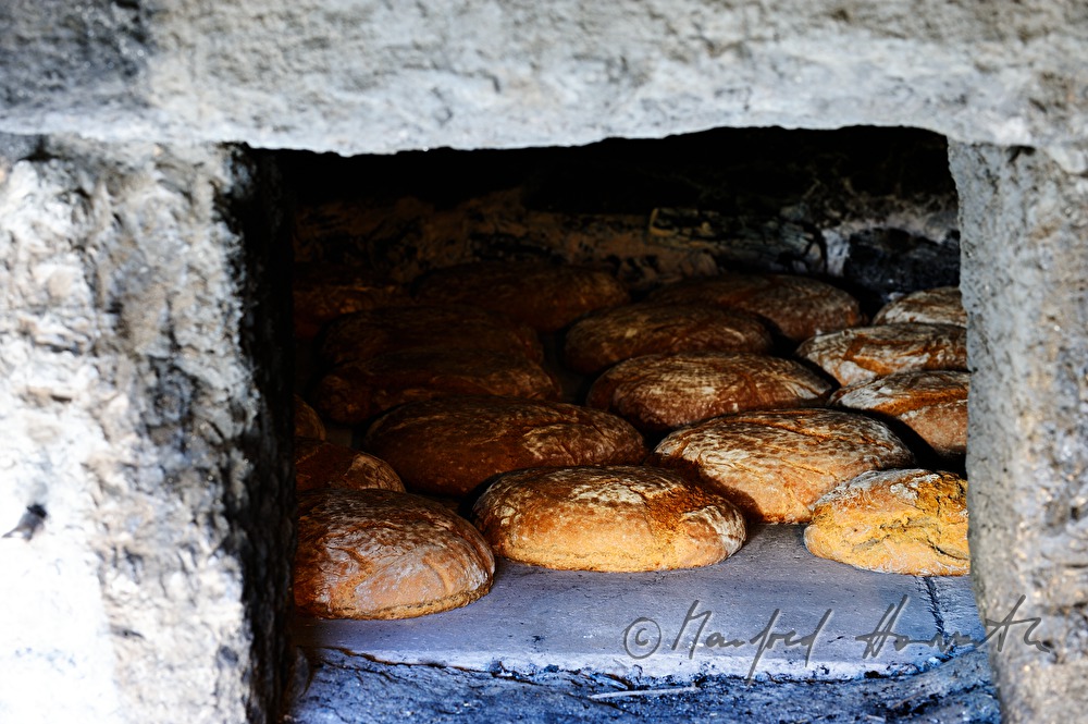 baking bread in the wood fired oven in the bakehouse