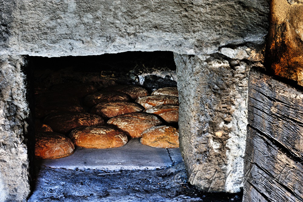 baking bread in the wood fired oven in the bakehouse