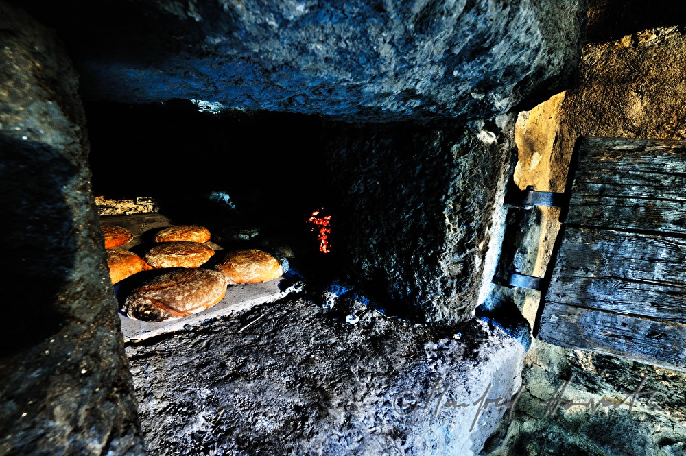 baking bread in the wood fired oven in the bakehouse