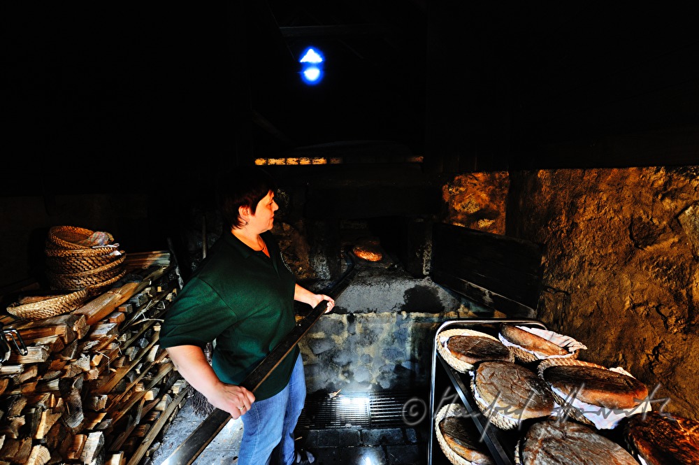 baking bread in the wood fired oven in the bakehouse