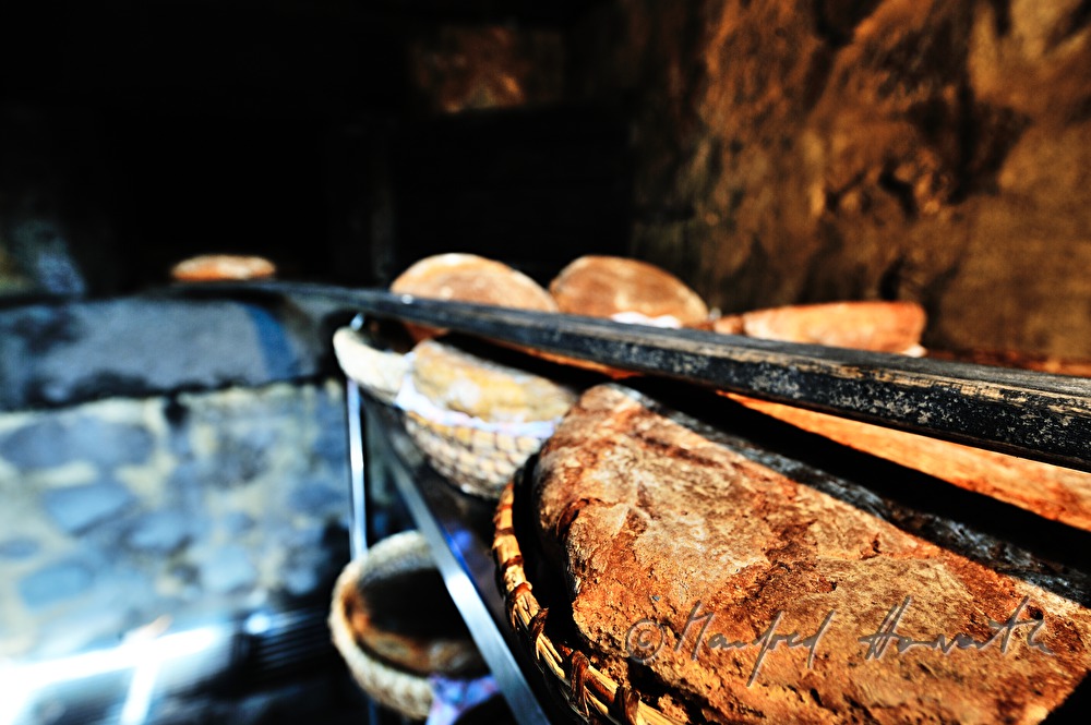 baking bread in the wood fired oven in the bakehouse