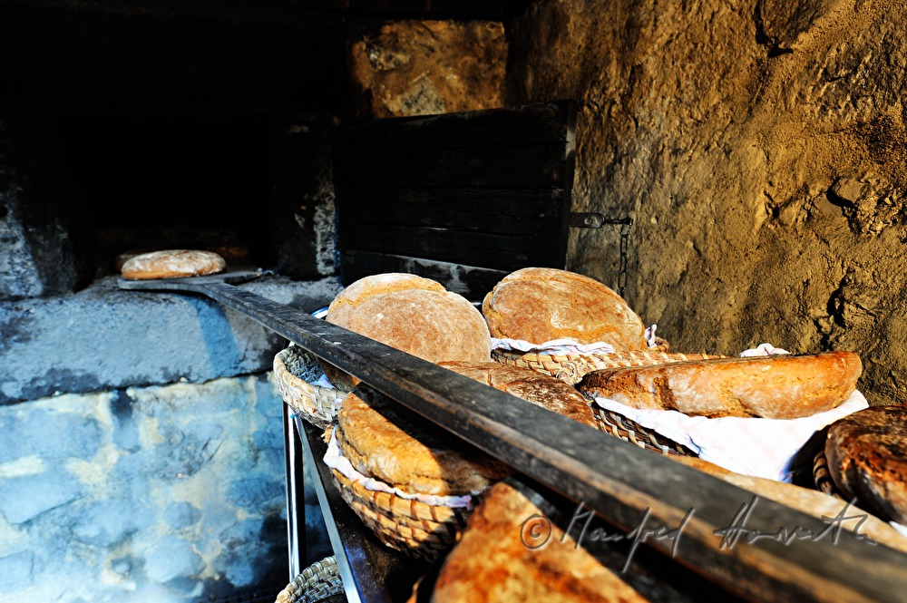 baking bread in the wood fired oven in the bakehouse