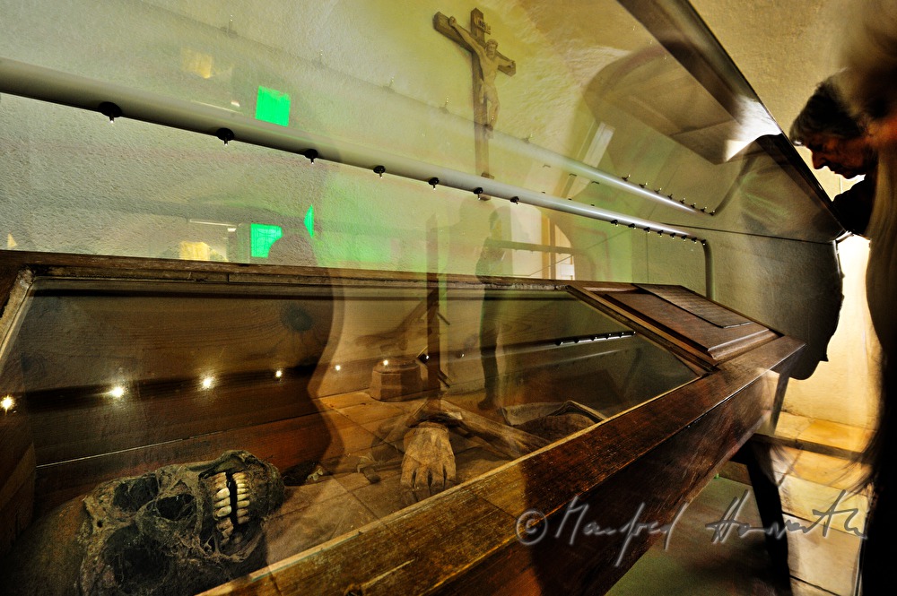 chamber tomb with a mummified priest on display