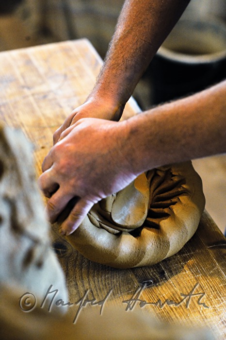 potter Joef Wieser kneading clay