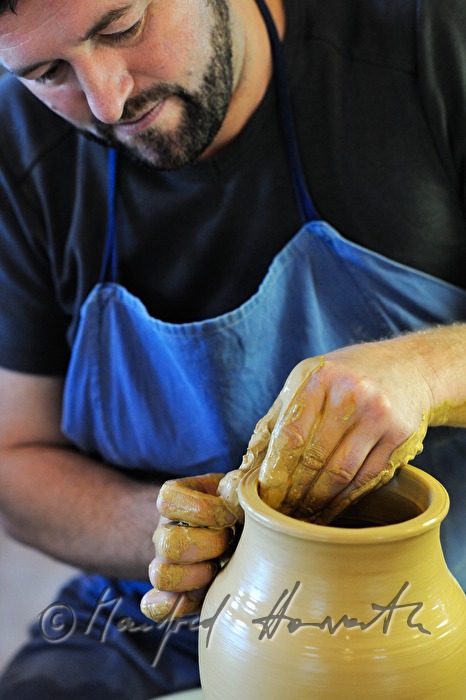 potter Joef Wieser working on the pottery wheel