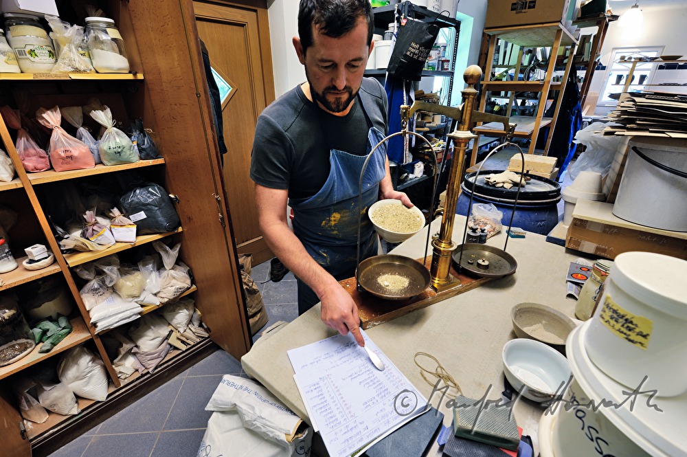 ceramist Wieser weighs grinded stone for glaze