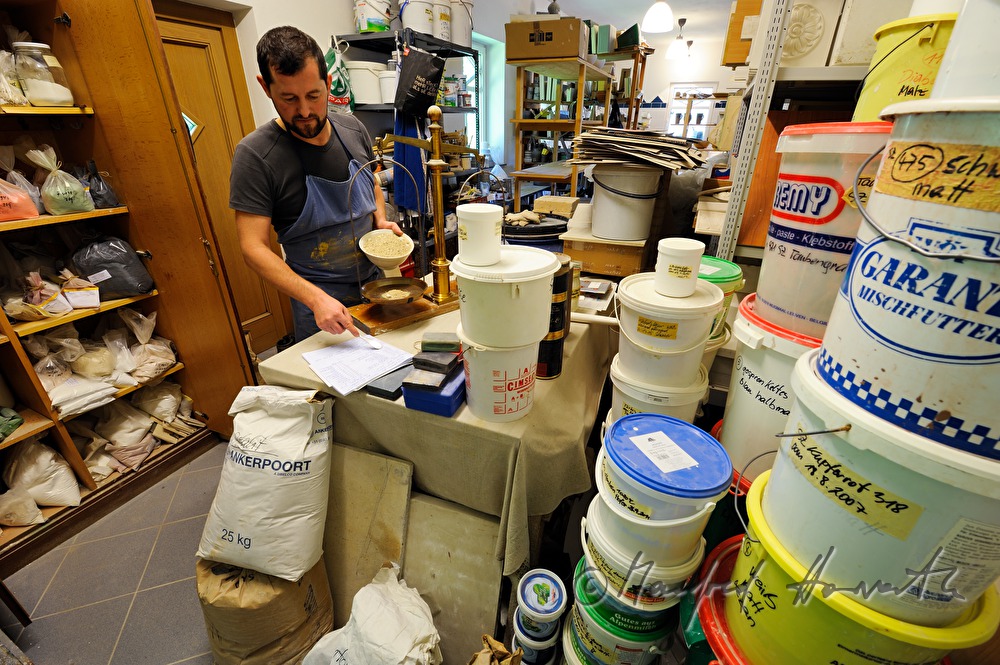 ceramist Wieser weighs grinded stone for glaze