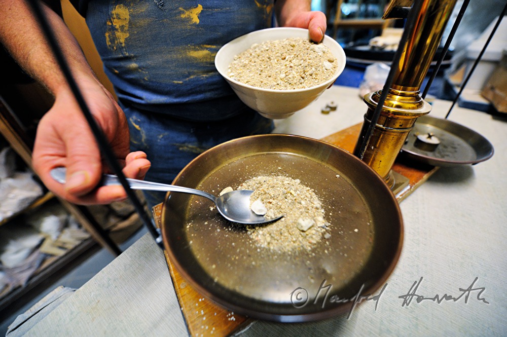 ceramist Wieser weighs grinded stone for glaze