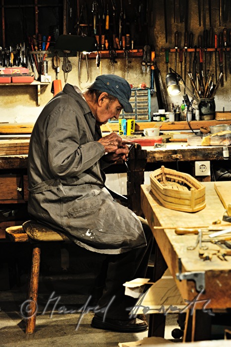 ship scale model maker Kurt Schaefer filing on the jaw vice