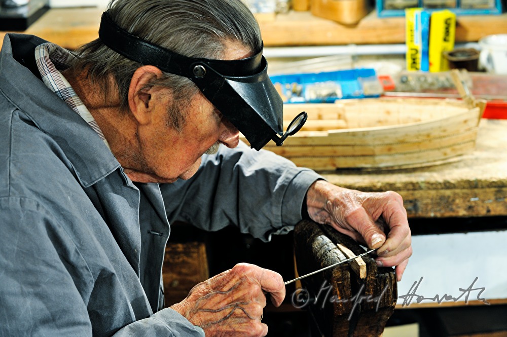 ship scale model maker Kurt Schaefer filing on the jaw vice