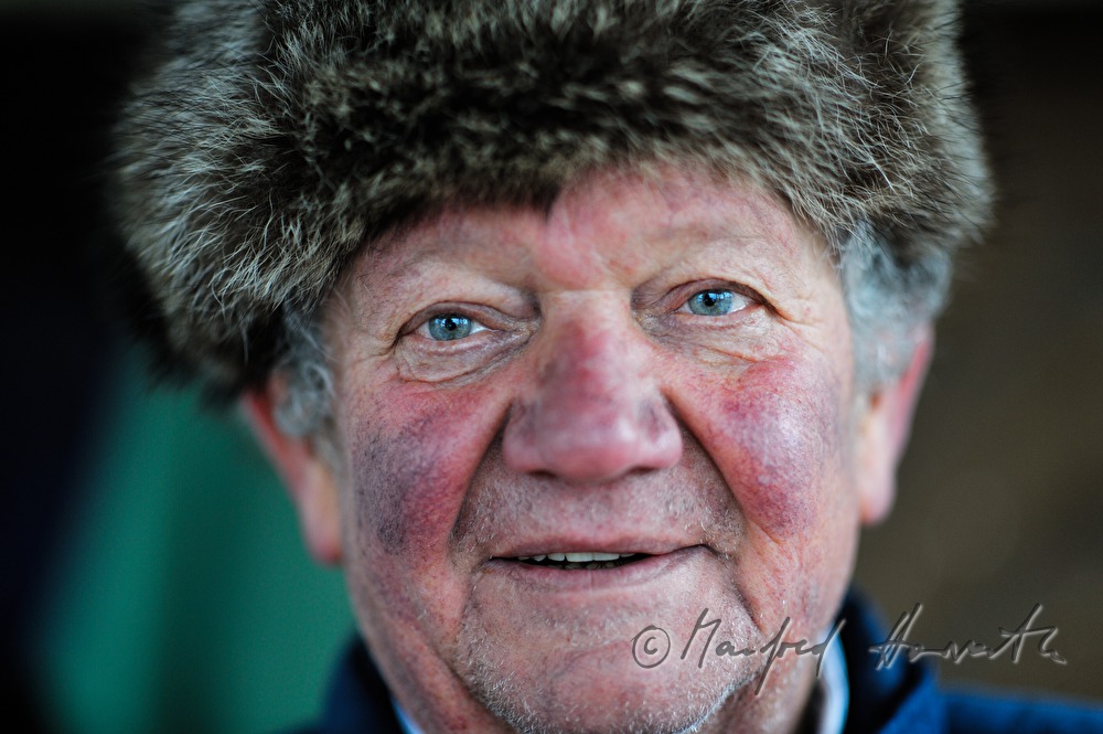 vintner with fur cap near his wine cellar