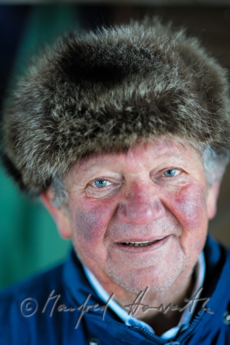 vintner with fur cap near his wine cellar