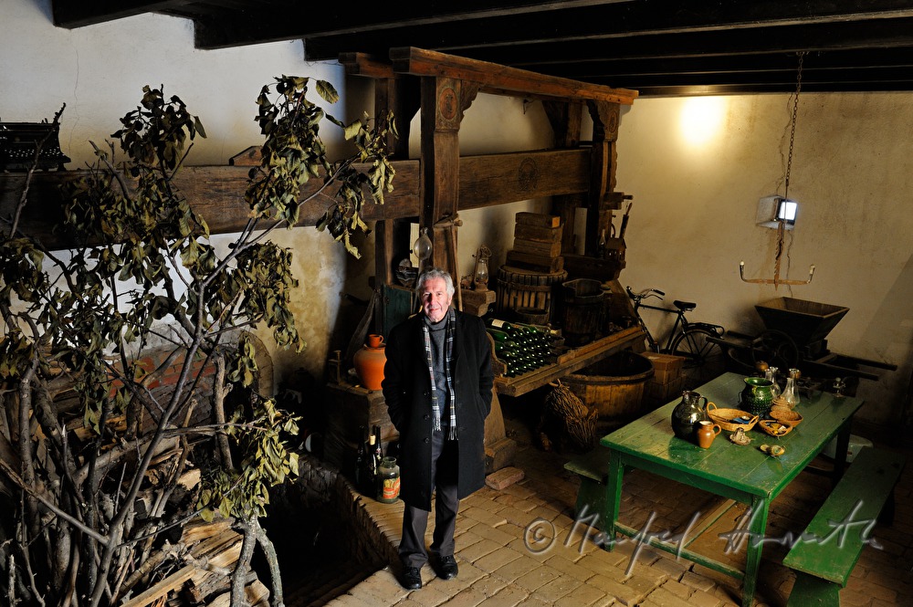 Alfred Komarek with wine press in his wine cellar
