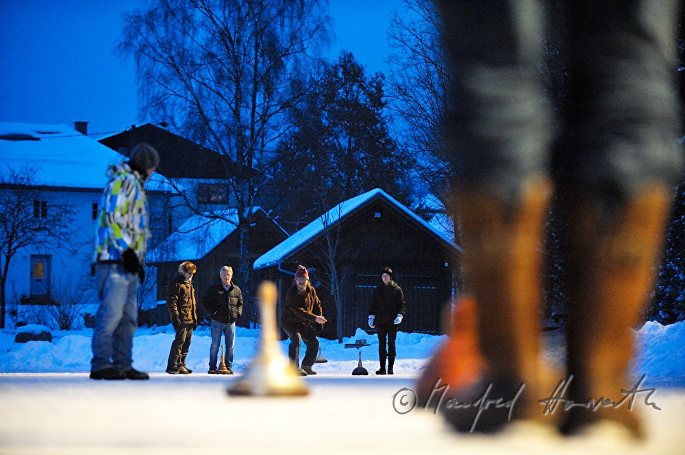 people are curling on a frozen lake in the village