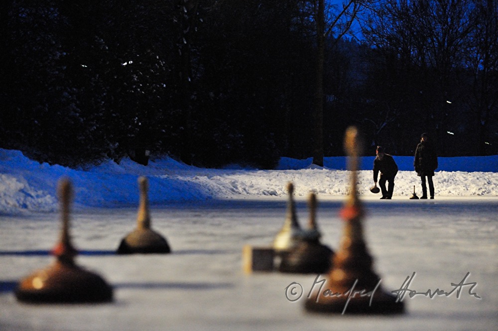 people are curling on a frozen lake in the village