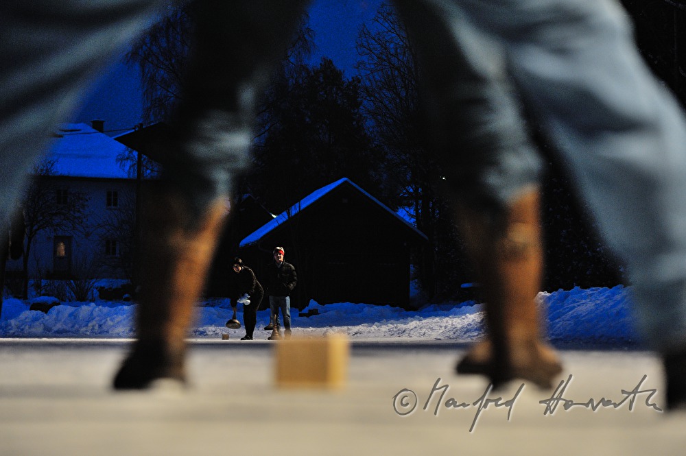 people are curling on a frozen lake in the village