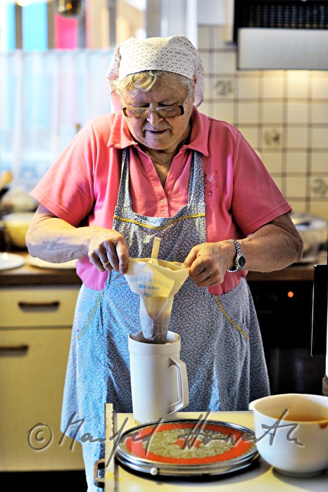 filling of Krapfen (doughnuts) with apricot jam