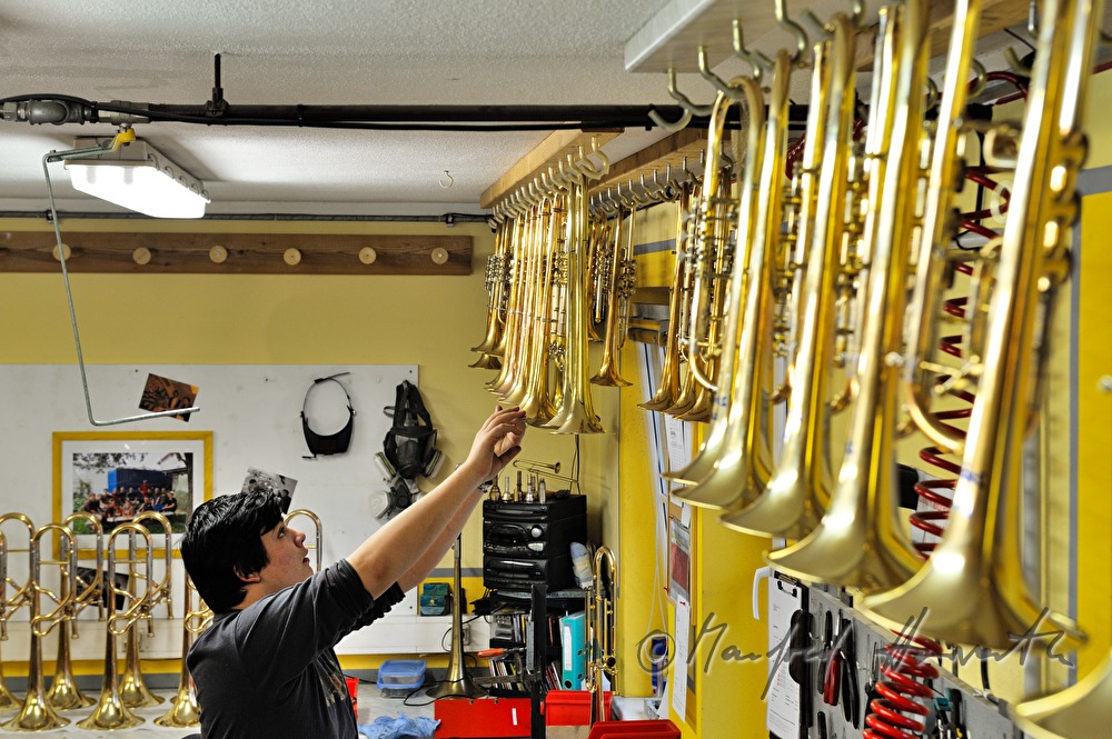 employee takes down a trumpet