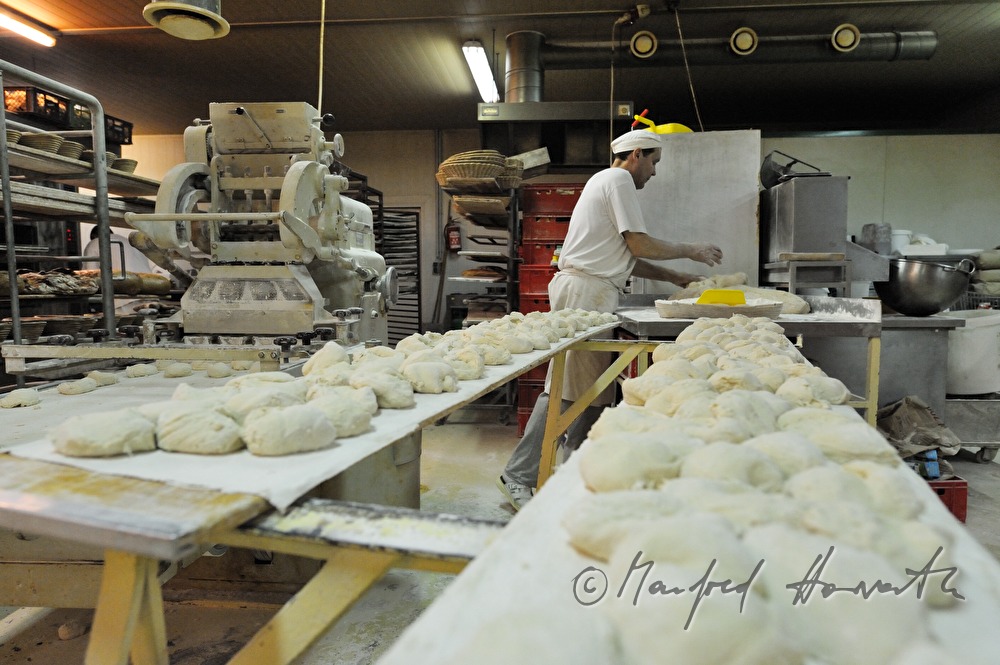 baker with portioned dough for the making of baguettes