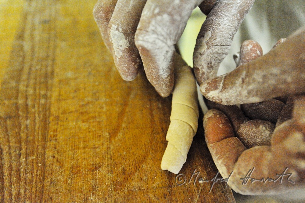 making of hand shaped pretzel rolls