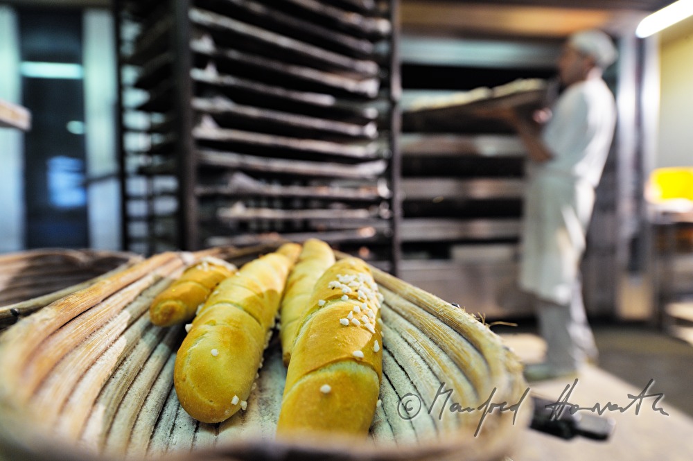 freshly baked sticks of pretzel near the baking oven