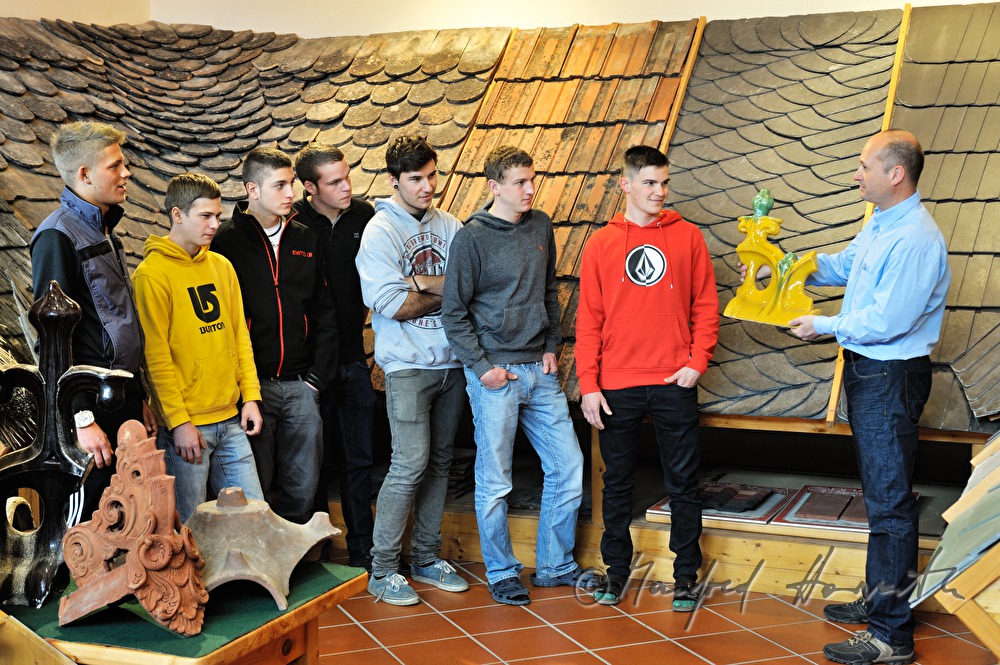 teacher and trainees in the museum for roofers