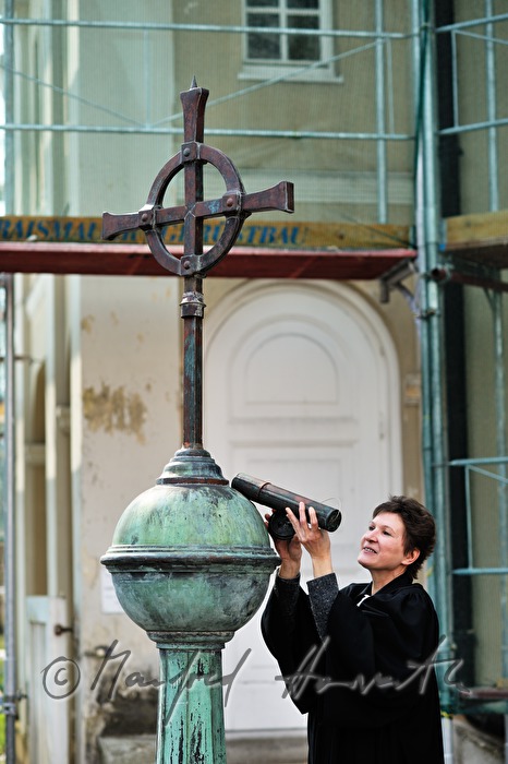 pastor puts the timecapsule into the steeple