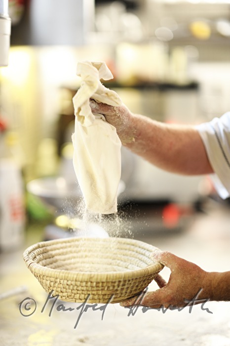 putting flour on the bread basket